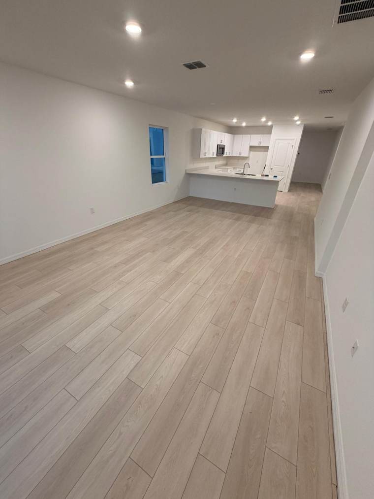Light wood-look plank floor in an open living area