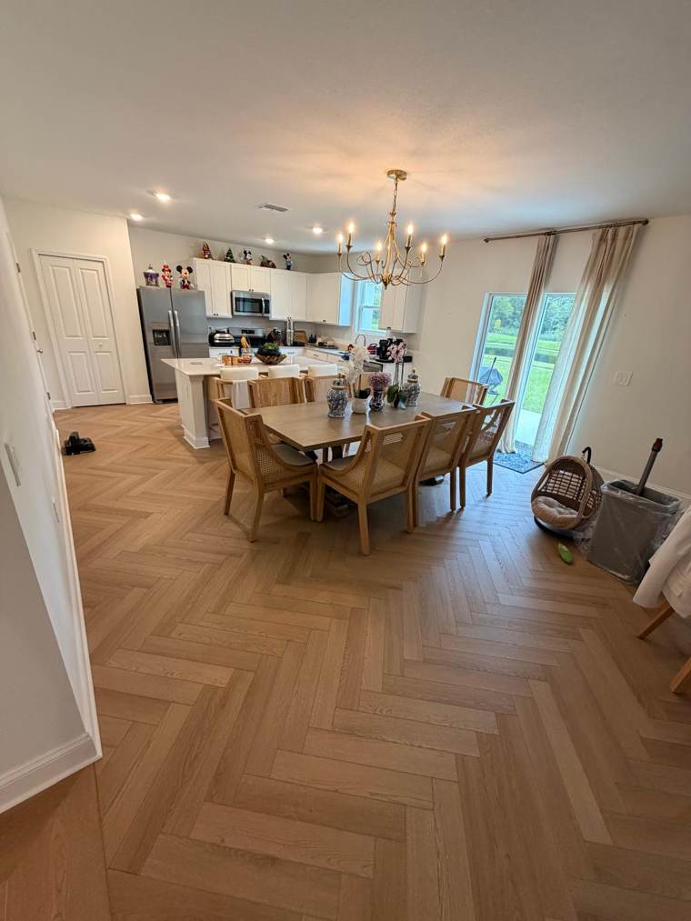 Herringbone wood-look floor in an open kitchen and dining room